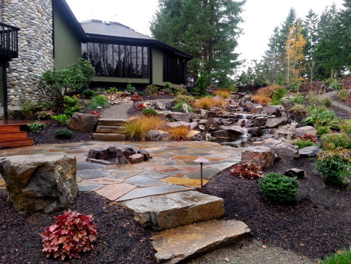 Fire pit and patio to gather by the water feature