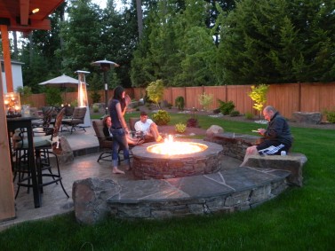 A family gathers around their new fire pit in this Sammamish backyard